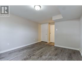 A room with a white door and a light on the ceiling.