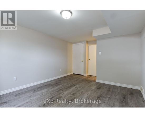 A room with a white door and a light on the ceiling.