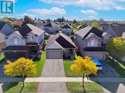 A bird's eye view of a residential neighborhood with houses and trees.