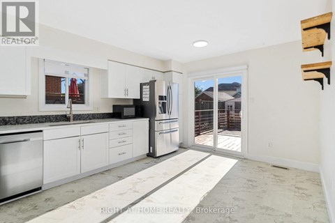 A kitchen with white cabinets and appliances is shown.