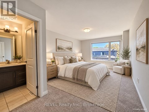 A bedroom with a large bed, a window with a view, and a painting on the wall.