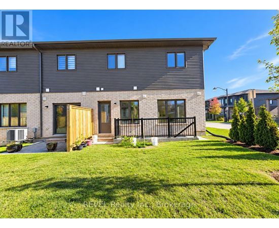 A modern house with a grey facade and a black gate.