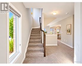 A staircase in a house with a carpeted floor.