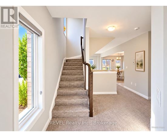 A staircase in a house with a carpeted floor.