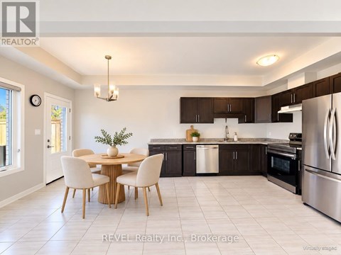 A modern kitchen with a dining table and chairs.