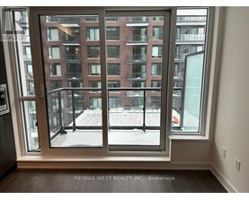 A view of a snowy courtyard through a large window.