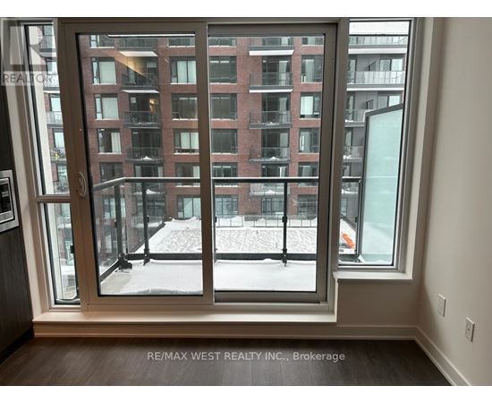 A view of a snowy courtyard through a large window.
