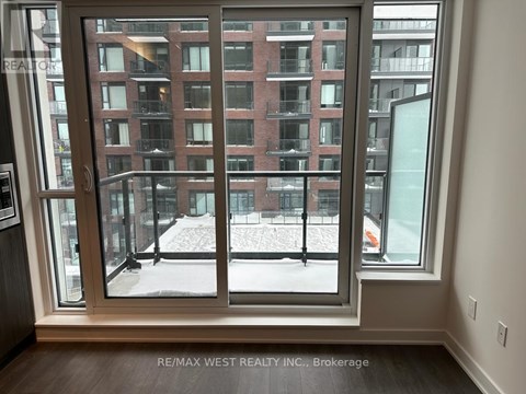 A view of a snowy courtyard through a large window.
