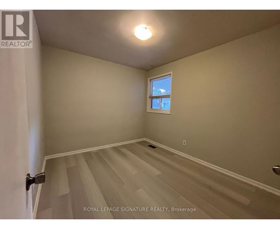A room with a window and a staircase.