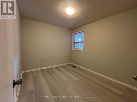A room with a window and a staircase.
