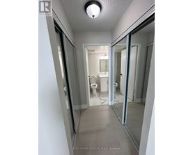 A white bathroom with a toilet and sink.