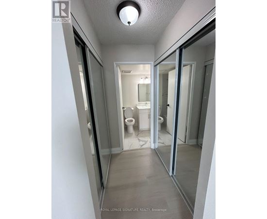 A white bathroom with a toilet and sink.