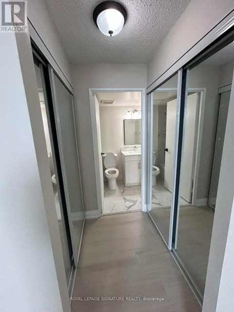 A white bathroom with a toilet and sink.