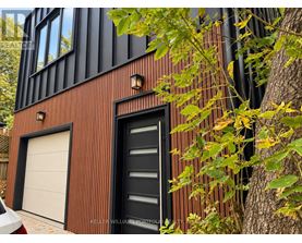 A modern house with a black door and a white garage door.