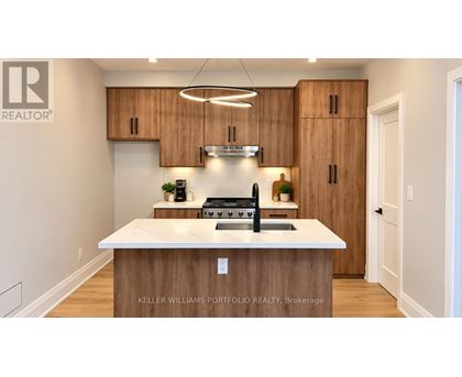 A modern kitchen with wooden cabinets and a white island.
