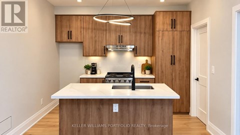 A modern kitchen with wooden cabinets and a white island.