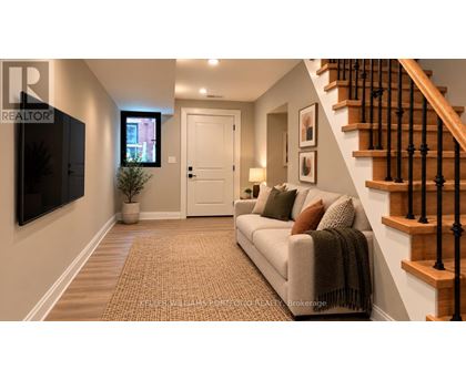A living room with a couch, a television, and a staircase.
