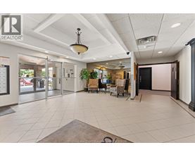 A realtor office with a white ceiling and a black door.