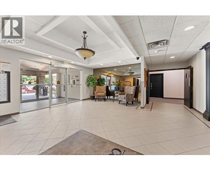 A realtor office with a white ceiling and a black door.