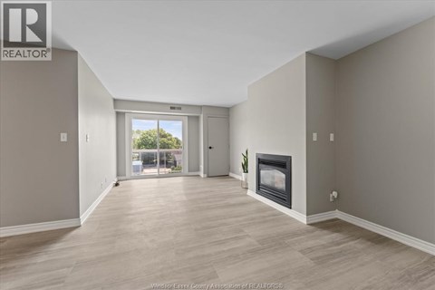 A spacious living room with a fireplace and sliding glass doors.