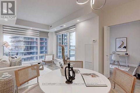 A well-lit, modern dining room with a large table and chairs.