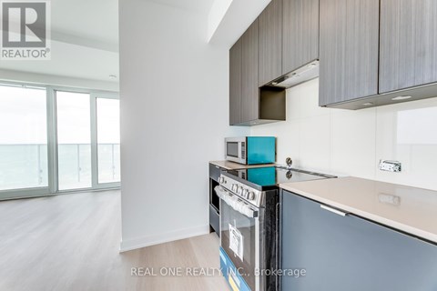 A modern kitchen with a dishwasher and a refrigerator.