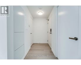 A white hallway with a door on the right.