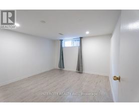 A room with a window and a door, with the text "INTERCITY REALTY INC., Brokerage" on the wall.