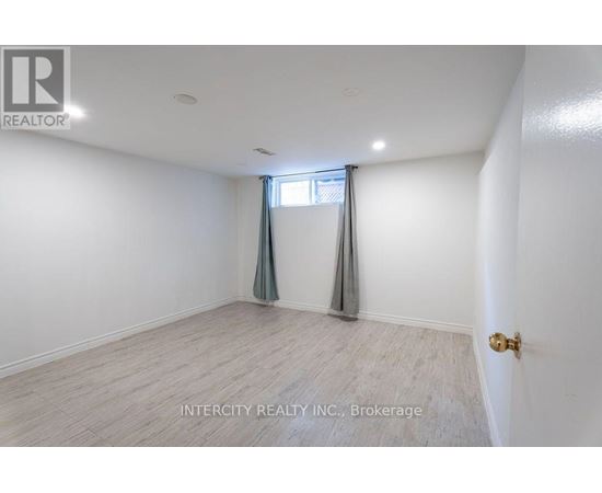 A room with a window and a door, with the text "INTERCITY REALTY INC., Brokerage" on the wall.