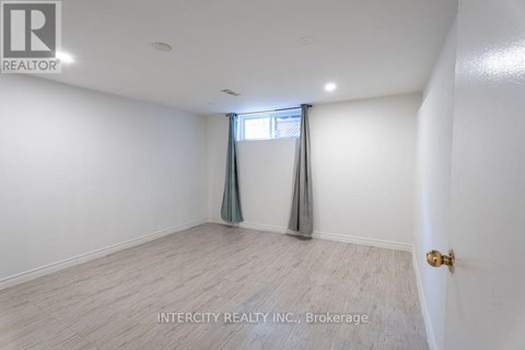 A room with a window and a door, with the text "INTERCITY REALTY INC., Brokerage" on the wall.