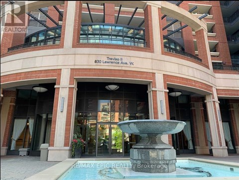A building with a fountain in front of it.