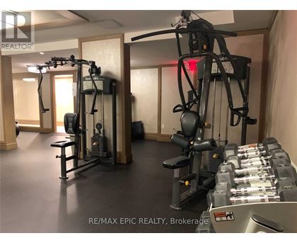 A gym with a variety of equipment including a treadmill, a stationary bike, and a rowing machine.