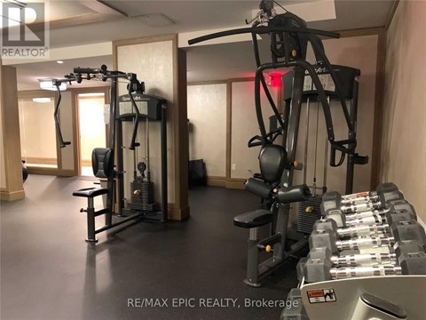 A gym with a variety of equipment including a treadmill, a stationary bike, and a rowing machine.