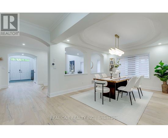 A dining room with a table set for four.