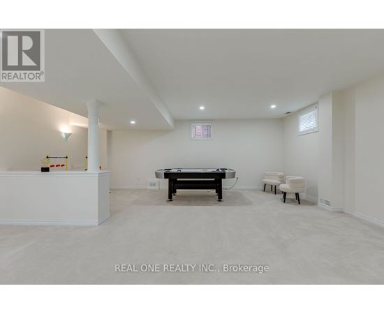 A room with a pool table and chairs.