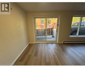 A room with a sliding glass door leading to a balcony.
