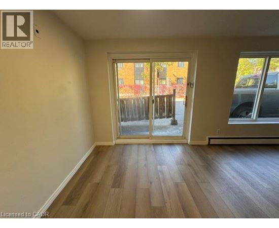 A room with a sliding glass door leading to a balcony.