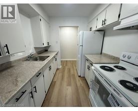 A kitchen with white appliances and cabinets.
