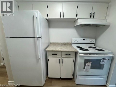 A white refrigerator and stove in a kitchen.