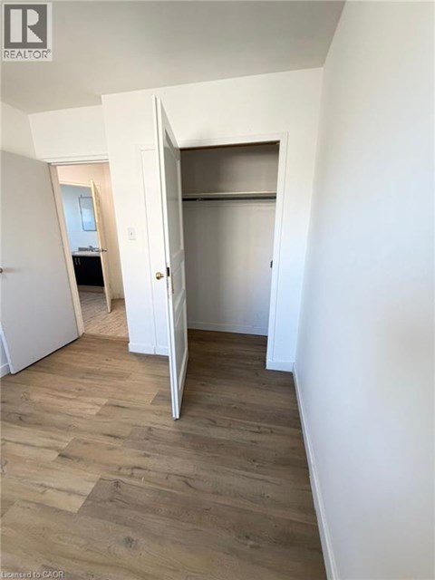 A room with a white door and a white wall.