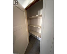 Empty pantry with white walls and shelves.