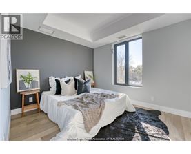A bedroom with a large bed and a window.