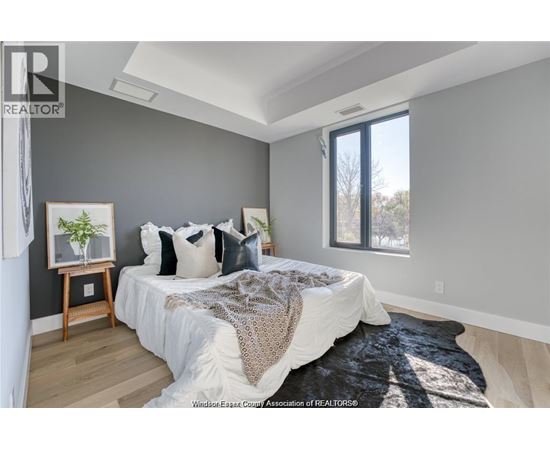 A bedroom with a large bed and a window.