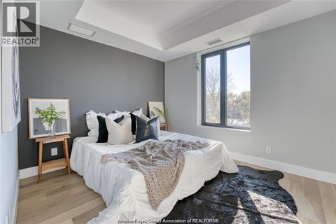 A bedroom with a large bed and a window.