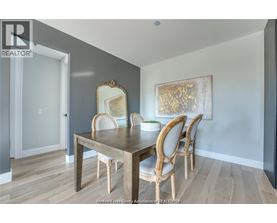 A dining room with a wooden table and chairs.