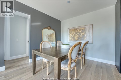 A dining room with a wooden table and chairs.