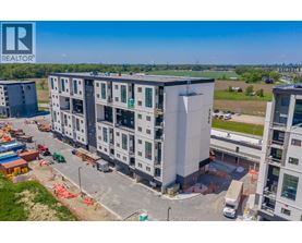 A large building under construction with a REALTOR® logo in the corner.