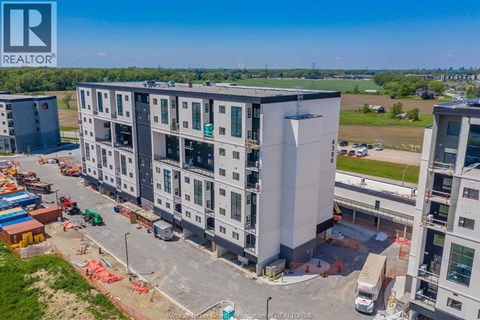 A large building under construction with a REALTOR® logo in the corner.