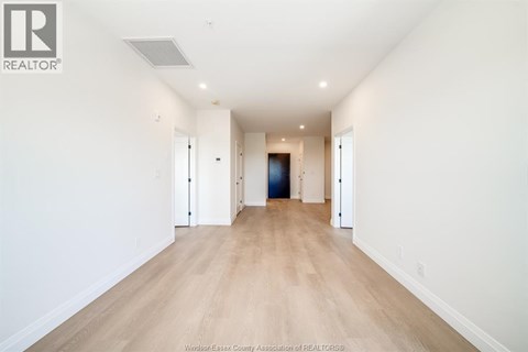 A long hallway with a door at the end.
