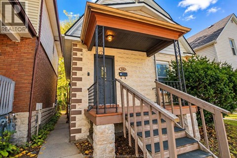 A house with a black door and a wooden porch.